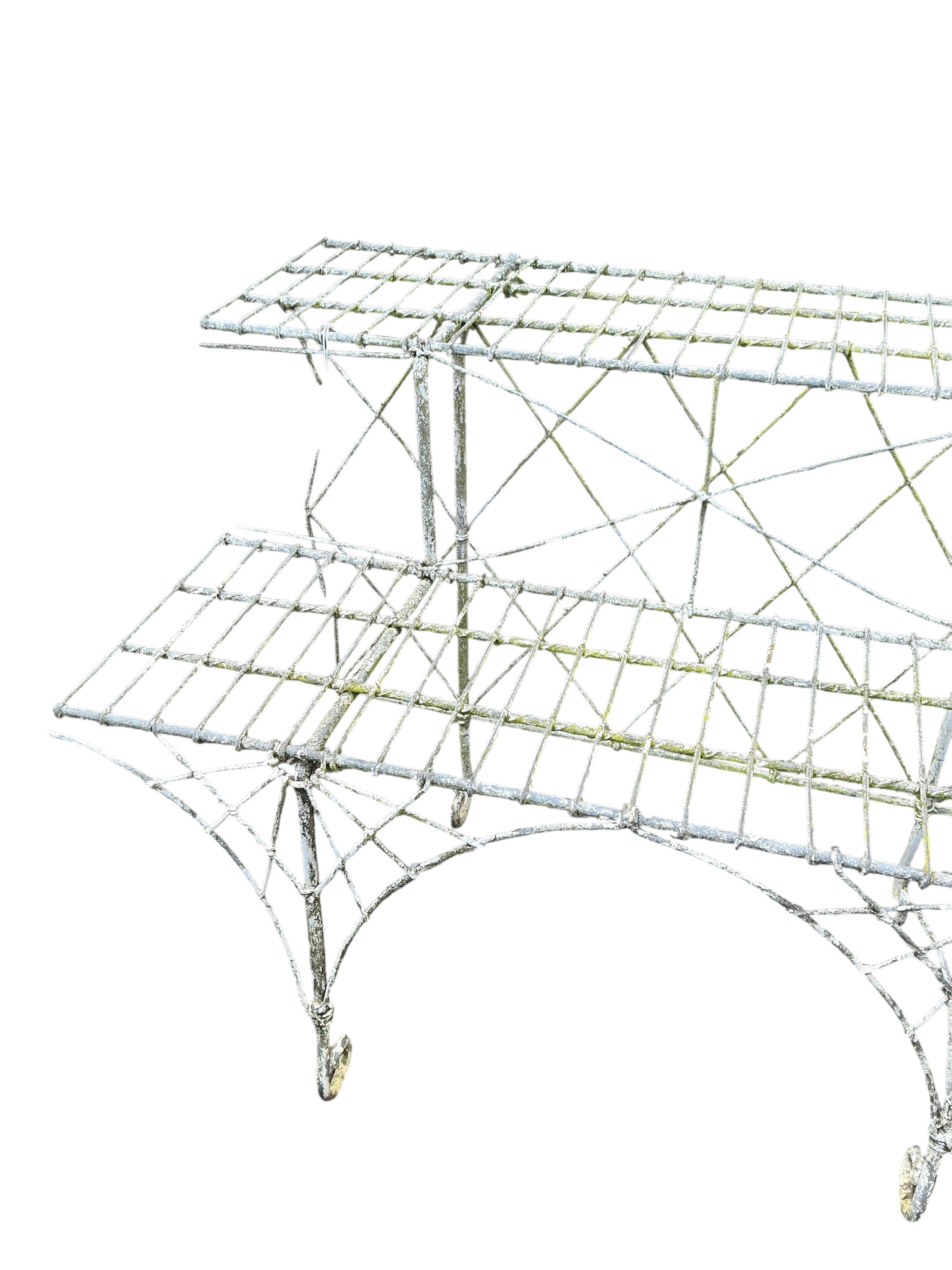 A Victorian painted wire work two tier pot stand, width 180cm, height 63cm